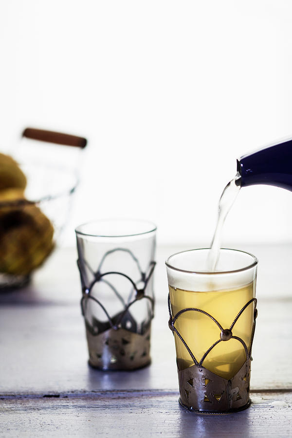 Quince Tea Being Poured Into A Tea Glass Photograph by Susan Brooks-dammann