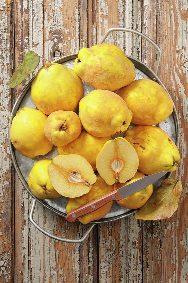 Quinces On A Rustic Wooden Table Photograph by Jean-christophe Riou