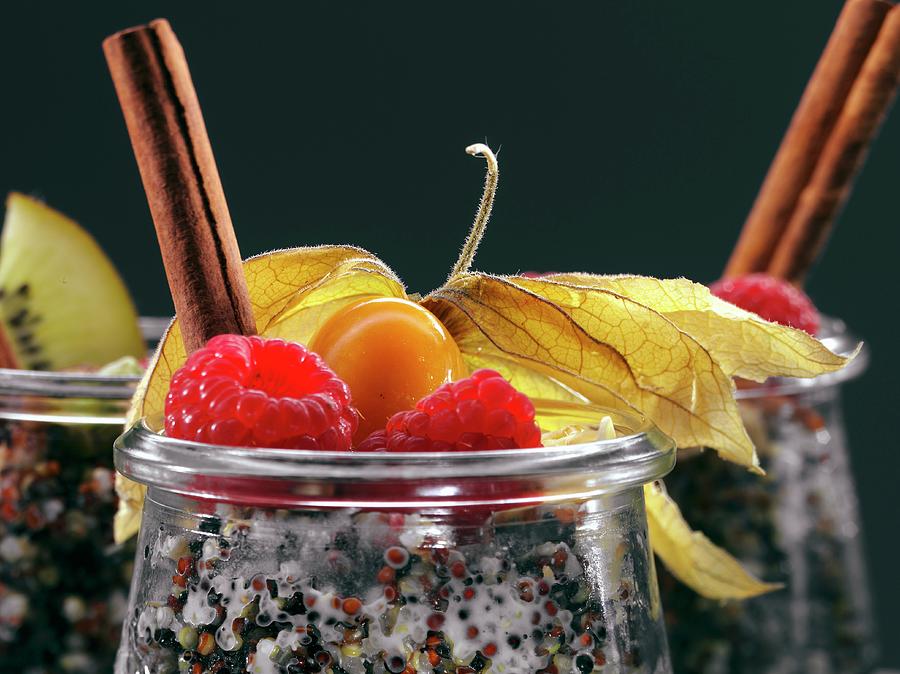 Quinoa Breakfasts With Rasberries, Cinnamon Sticks And Physalis In Glasses Photograph by Christian Schuster