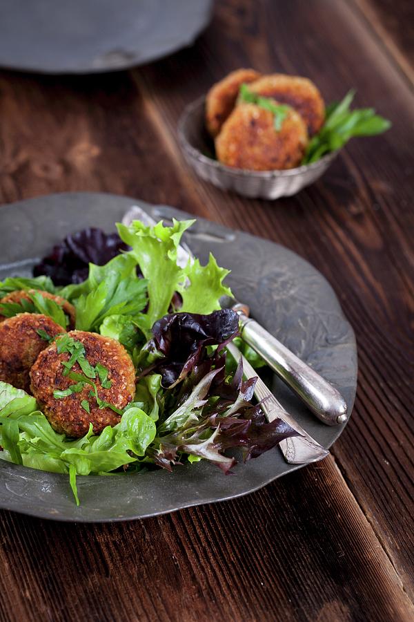 Quinoa Fritters On A Bed Of Lettuce Photograph by Elisabeth Von Plnitz-eisfeld