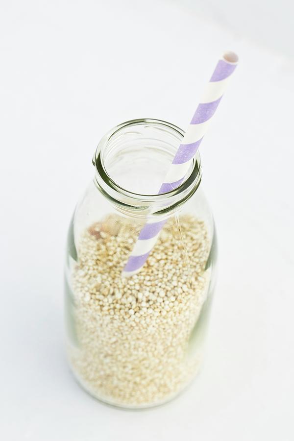 Quinoa In A Milk Bottle With A Straw Photograph by Esther Hildebrandt