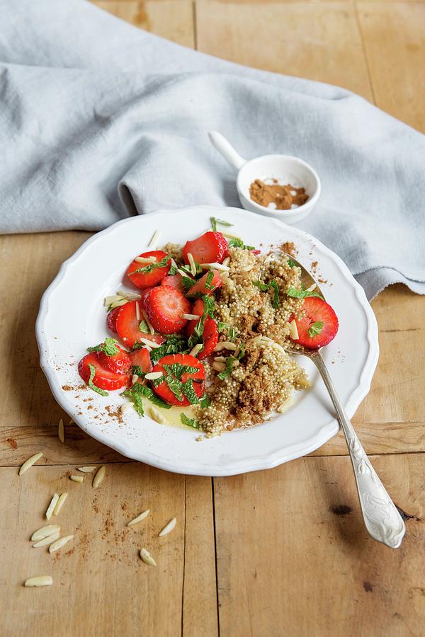 Quinoa Porridge With Minced Strawberries And Almond Sticks Photograph by Claudia Timmann