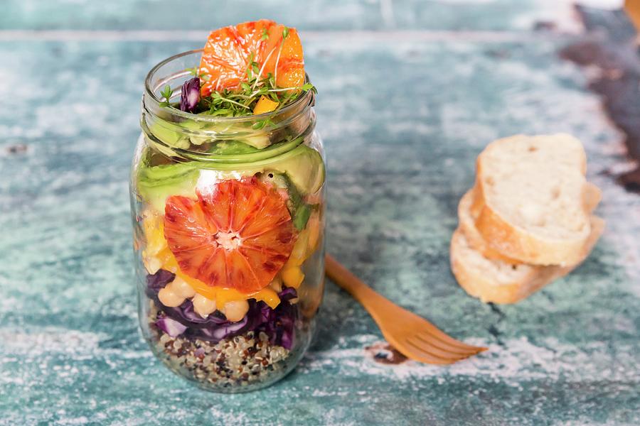 Quinoa Salad In A Glass Jar With Red Cabbage, Chickpeas, Avocado, Blood Orange And Cress Photograph by Sandra Rsch