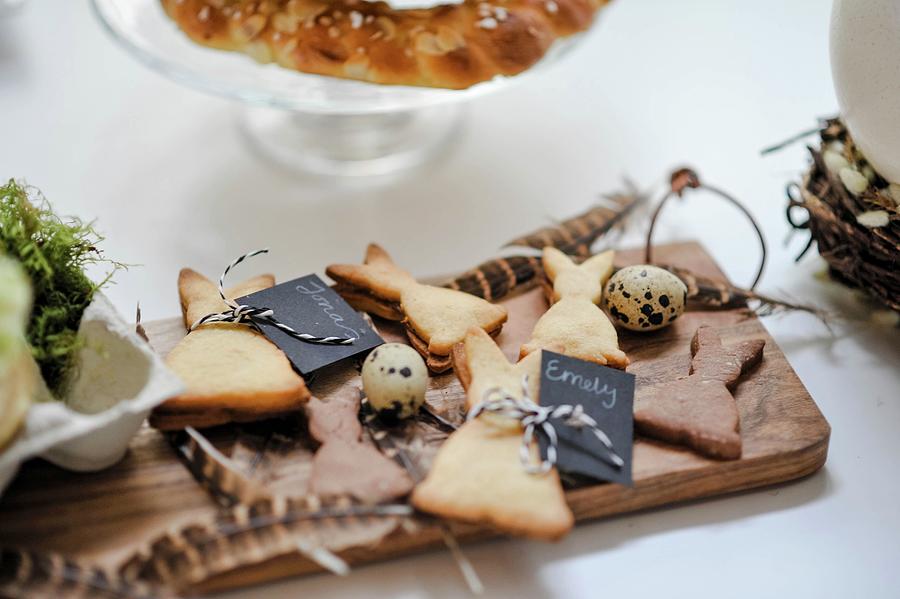 Rabbit-shaped Biscuits With Name Tags On Wooden Board Photograph by Alexandra Feitsch