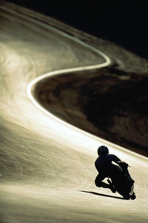 Racing Motor Cyclist Silhouetted On Photograph by Anton Want Racing Motor Cyclist Silhouetted On Photograph by Anton Want