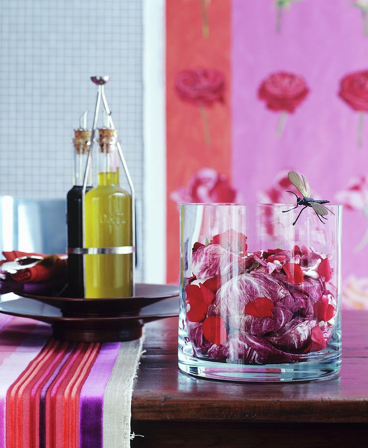 Radicchio And Rose Petals In Glass Bowl And Olive Oil On Wooden Table Photograph by Matteo Manduzio