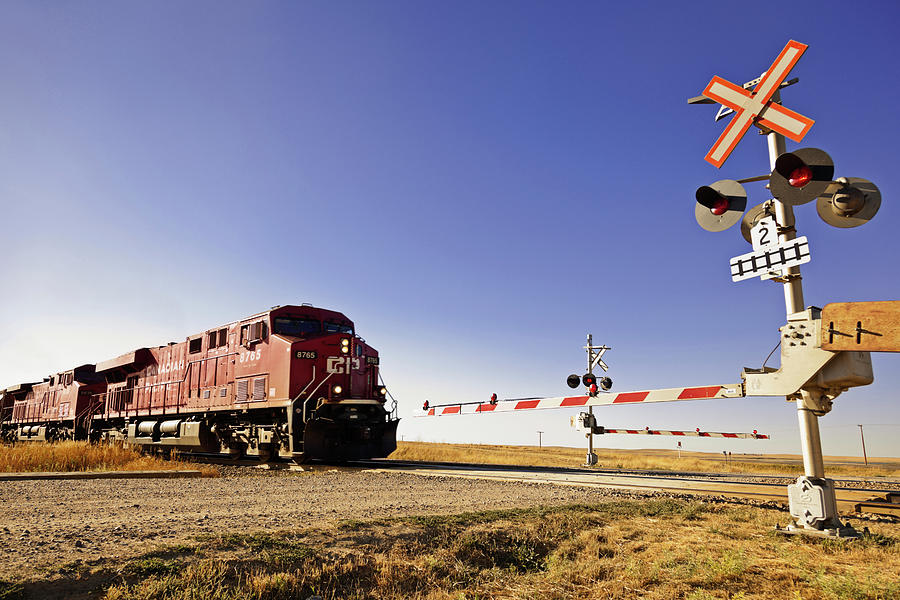 Railway Crossing Line At Highway 1 West To Alberta, Saskatchewan, Canada Photograph by Jalag / Arthur F. Selbach