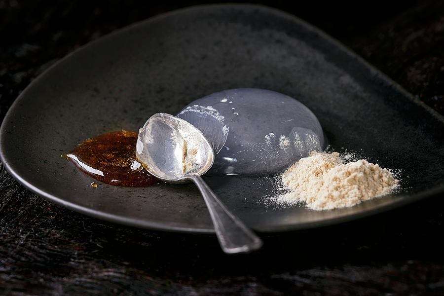 Raindrop Cake With Caramel Sauce And Fried Flour On Ceramic Plate Photograph by Natasha Breen