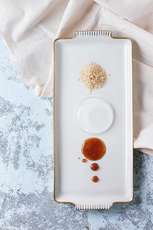 Raindrop Cake With Caramel Sauce And Fried Flour On Rectangular Plate Photograph by Natasha Breen