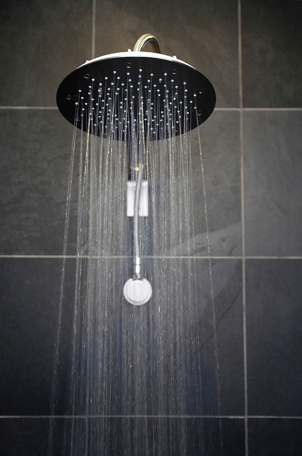Rainfall Shower Head In Bathroom With Black Tiles Photograph by Kennet House Of Pictures / Havgaard