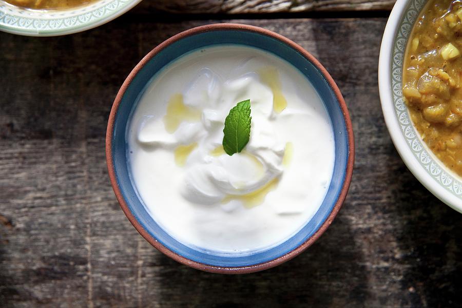 Raita With A Mint Leaf In A Ceramic Bowl Photograph by George Blomfield