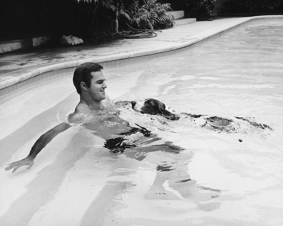 Burt Reynolds Photograph - Rare 1960s Burt Reynolds Stud Beefcake Actor In Pool With Dog by Globe Photos