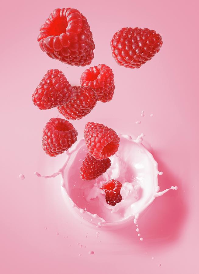 Raspberries Falling Into Raspberry Milk Photograph by Krger & Gross