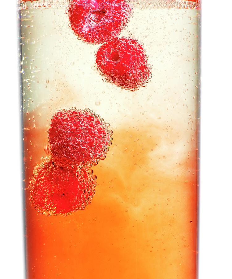 Raspberries In Champagne And Aperol close-up Photograph by Feig & Feig
