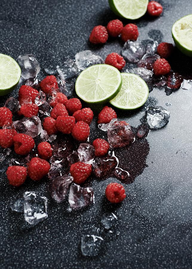 Raspberries, Limes And Ice Cubes Photograph by Amanda Stockley