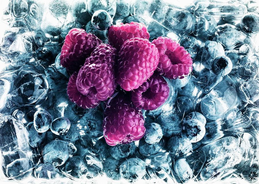 Raspberries On Frozen Blueberries Photograph by Michael Van Emde Boas