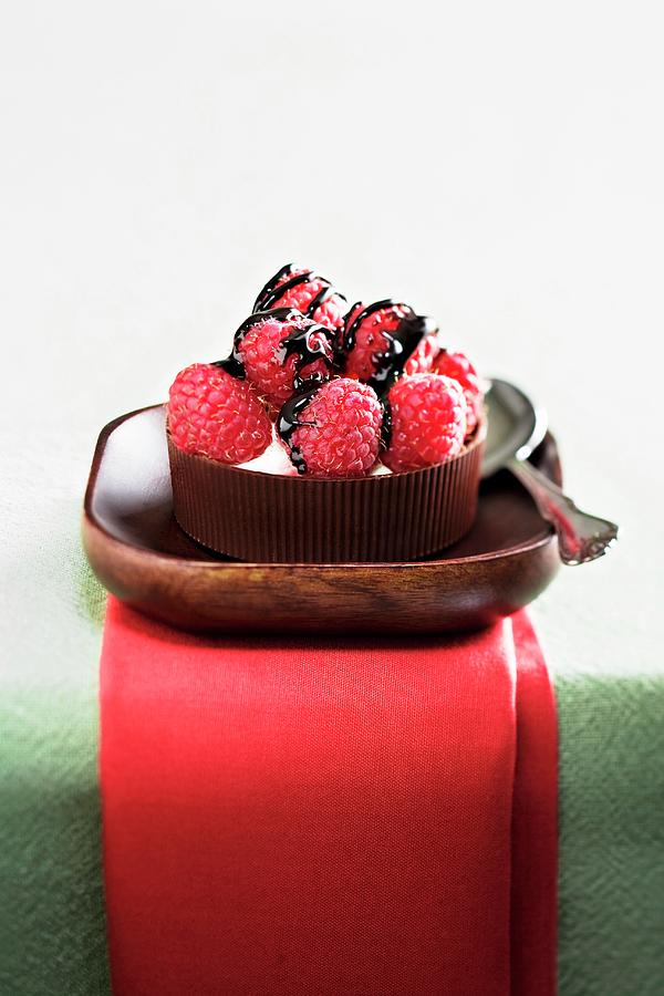 Raspberries With Chocolate Drizzle On Mascarpone Cheese In A Chocolate Cup; Spoon Photograph by Fleischman, Richard