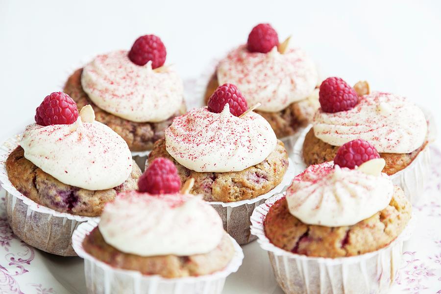 Raspberry And Almond Muffins Decorated With Buttercream And Dried Raspberry Powder Photograph by Sarah Coghill