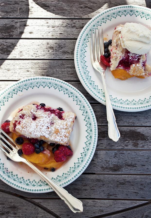 Raspberry, Blueberry And Peach Cobbler On Plates Photograph by Ryla Campbell