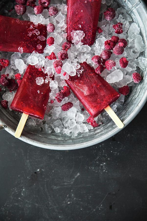 Raspberry Ice Lollies On Sticks In An Ice Bucket Photograph by Sneh Roy