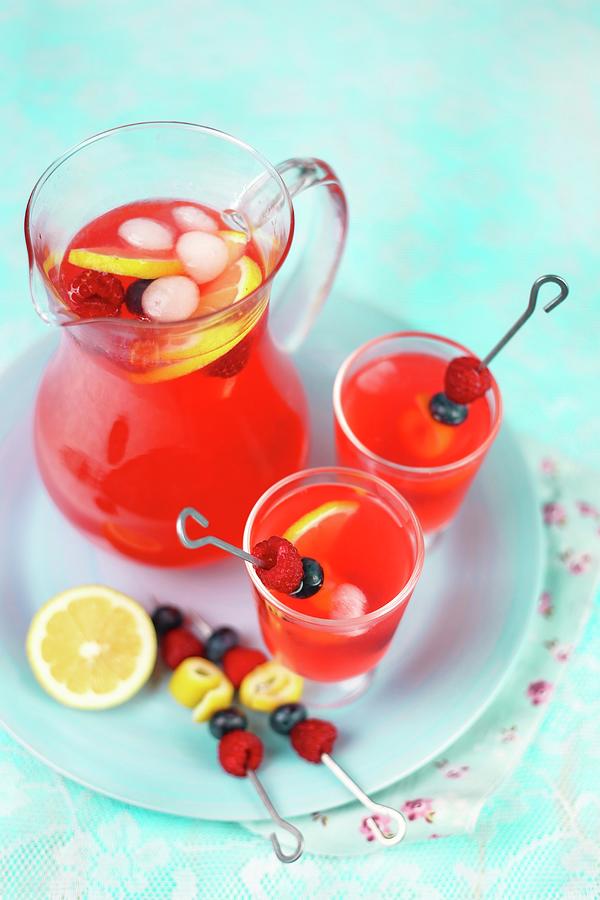 Raspberry Lemonade In A Glass Jug And Glasses Photograph by Claudia Gargioni