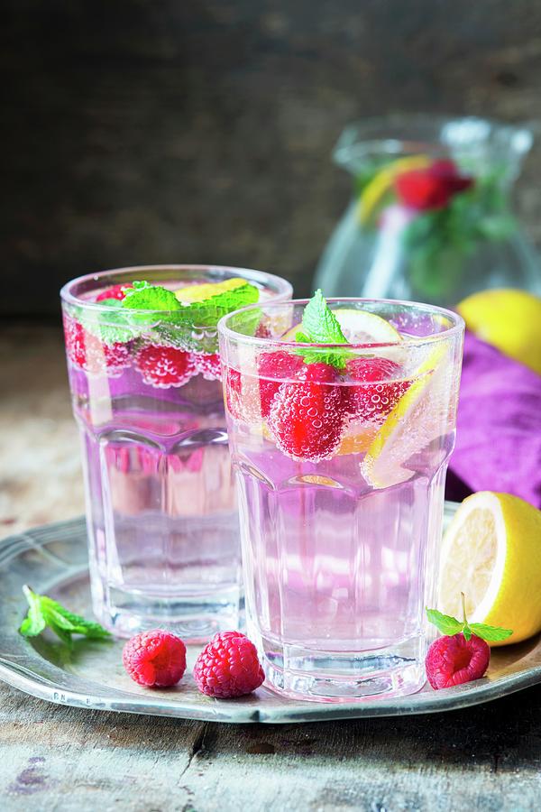 Raspberry Lemonade With Lemon Slices And Mint Photograph by Irina Meliukh