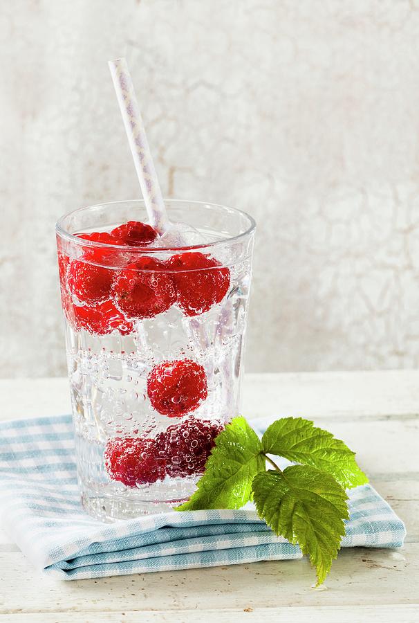 Raspberry Spritzer: Mineral Water Flavoured With Fresh Raspberries Photograph by Birgit Twellmann