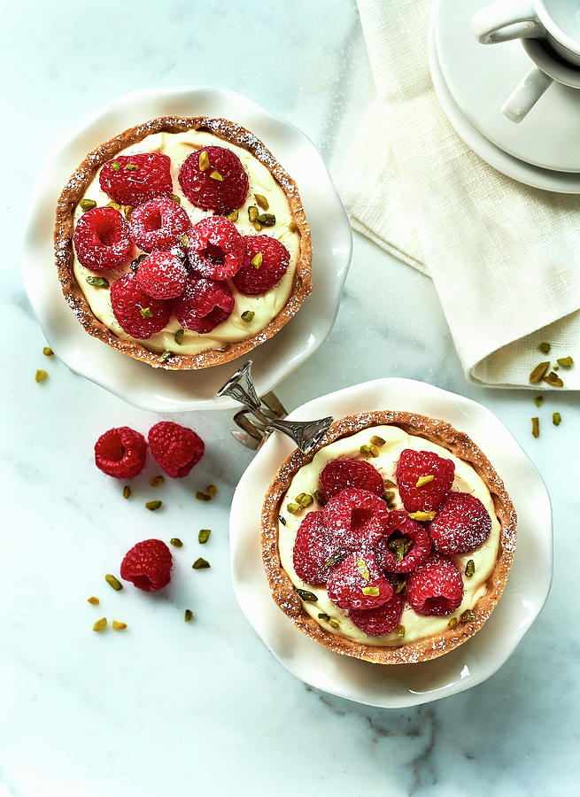 Raspberry Tartlets With Vanilla Pudding On A Marble Platter Photograph by Stefan Schulte-ladbeck