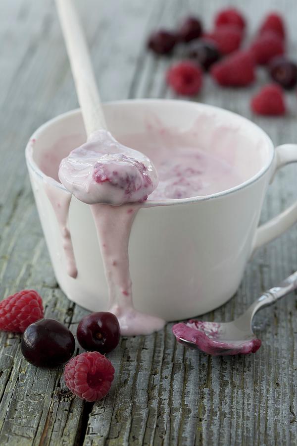 Raspberry Yoghurt In A White Cup Photograph by Martina Schindler