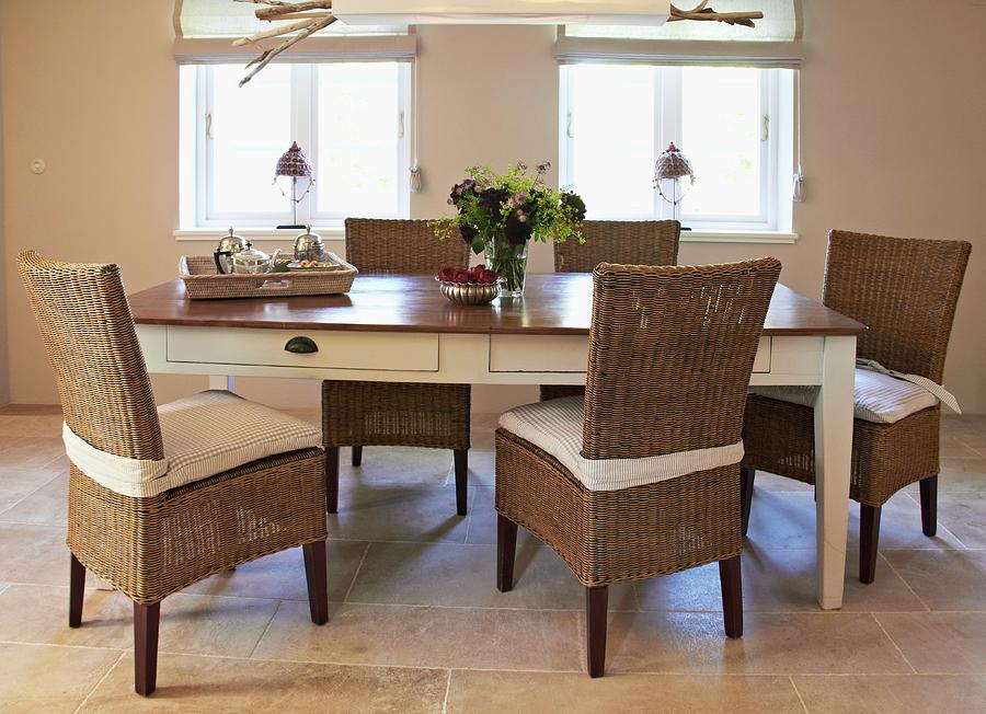Rattan Chairs Around Country-house Table With White Base And Dark Top Photograph by Misha Vetter