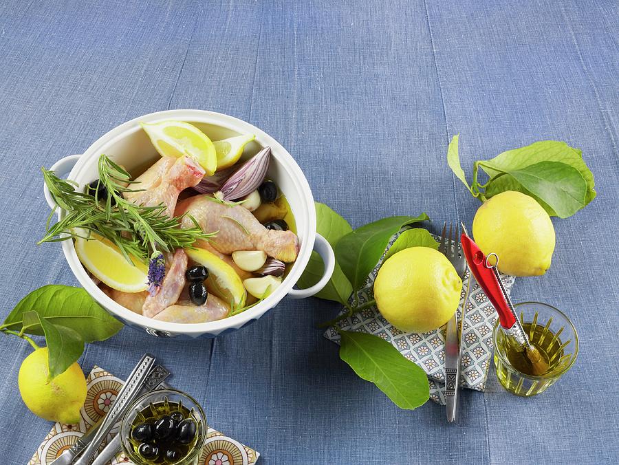 Raw Chicken Parts With Lemon Wedges, Olives, Onions And Rosemary Photograph by Luzia Ellert