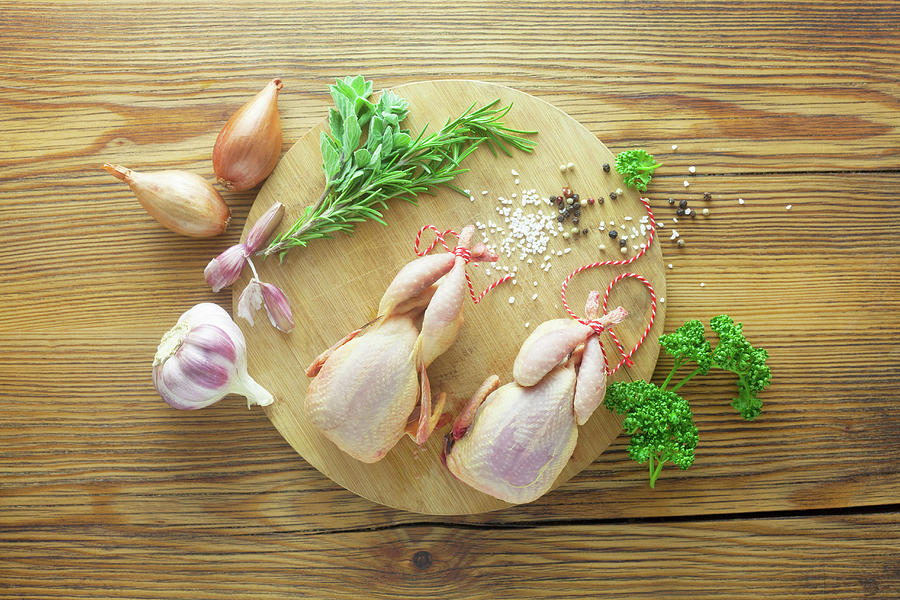 Raw Corn-fed Quails With Ingredients On A Wooden Surface Photograph by Barbara Pheby
