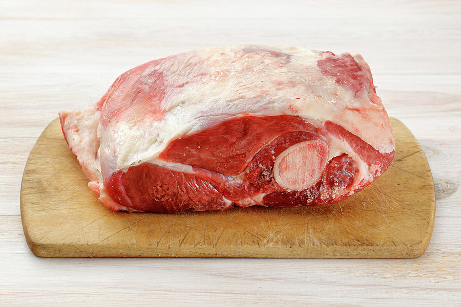 Raw Lamb Shoulder On A Chopping Board Photograph by Petr Gross