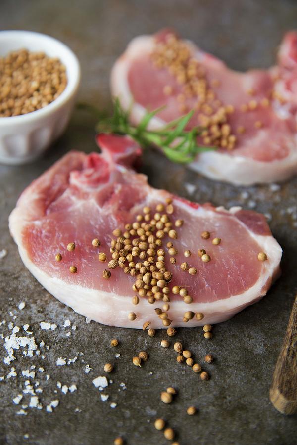 Raw Pork Chops Seasoned With Coriander, Tarragon And Sea Salt Photograph by Joana Leito