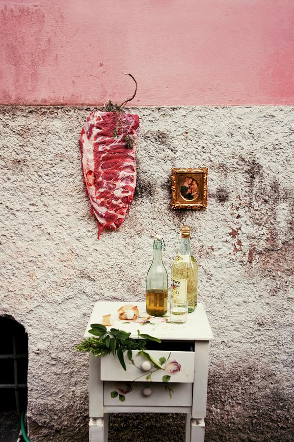 Raw Pork Ribs Hanging On The Wall Of A House, Next To A A Gold-framed Picture Photograph by Brinkop, Maria