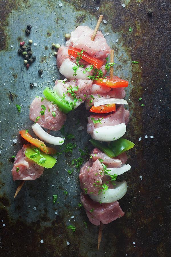 Raw Pork Skewers With Peppers And Onions On A Metal Surface Photograph by Barbara Pheby