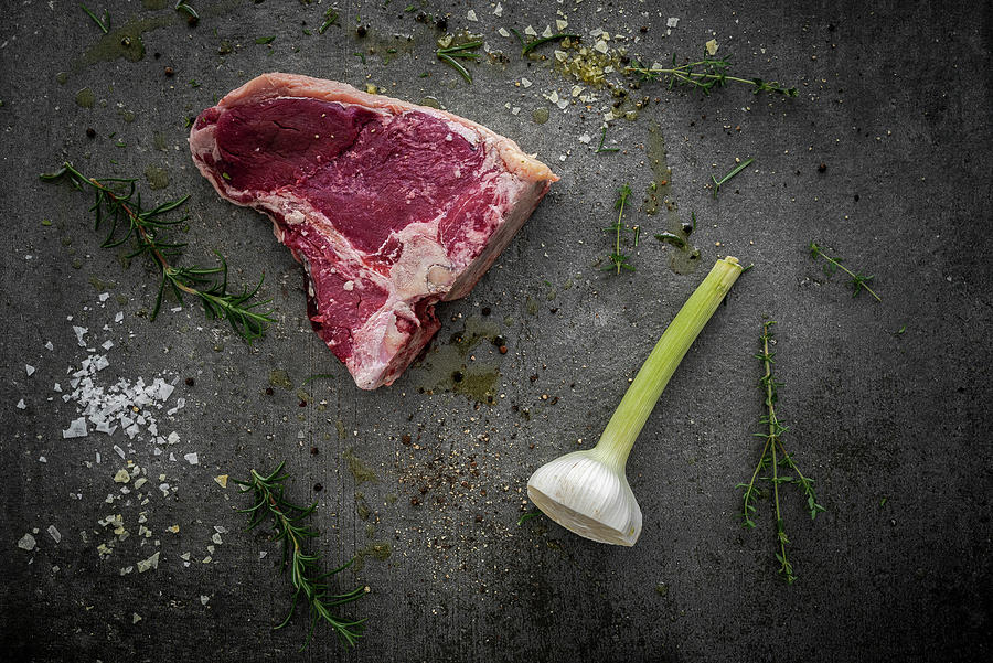 Raw T-bone Steak, Rosemary, Thyme, Halved Garlic Bulb, Spices And Sea Salt Photograph by M. Nlke