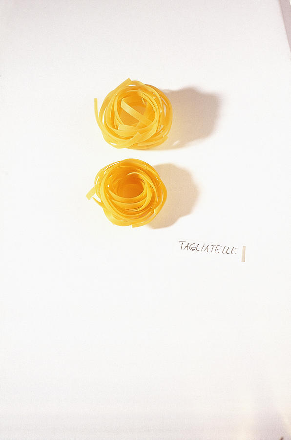 Raw Taglierini Noodles On White Background, Overhead View Photograph by ...