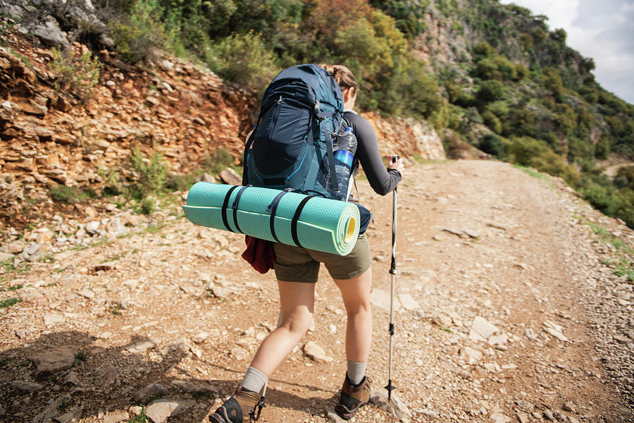 Rear View Of Female Hiker Climbing Up To The Top Of The Mountain ...