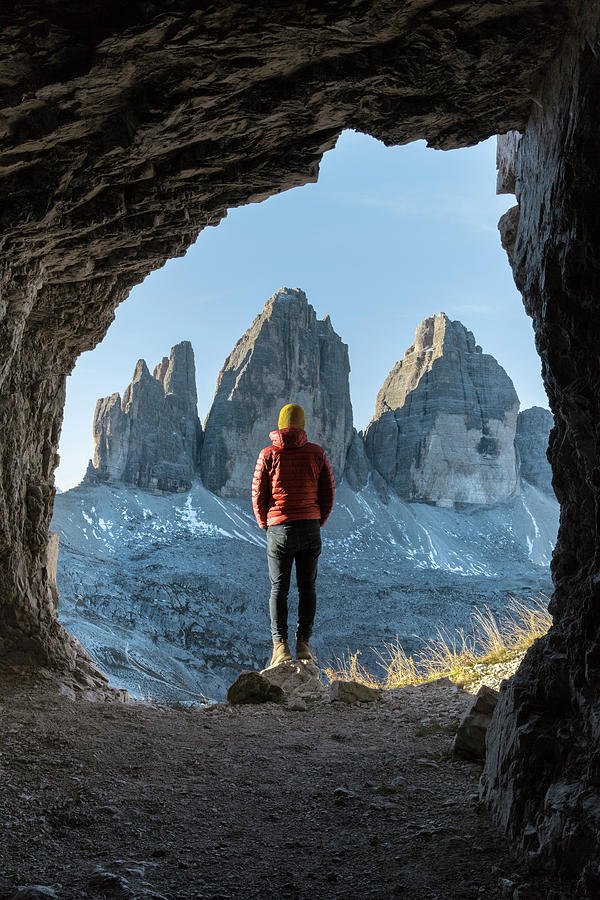 Rear View Of Man Standing On Rock Seen Through Cave Photograph by Cavan ...