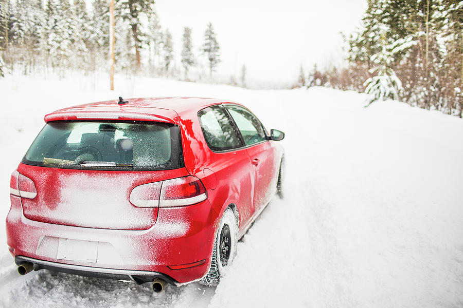 Rear View Of Red Sports Car Driving On Snowy Road. Photograph by Cavan