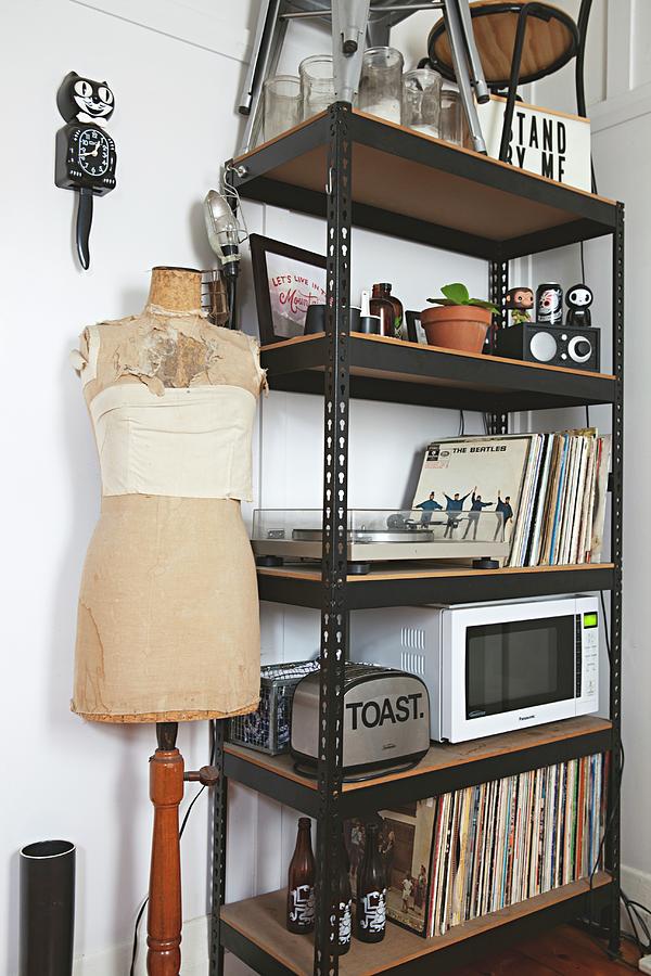 Records, Toaster And Microwave On Black Metal Shelves Next To Tailors Dummy And Cat-shaped Clock Photograph by Natalie Jeffcott