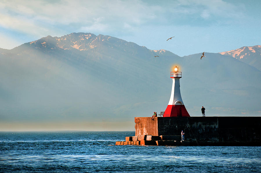 Red And White Lighthouse With People And Mountains In Background Photograph by Dan Barba