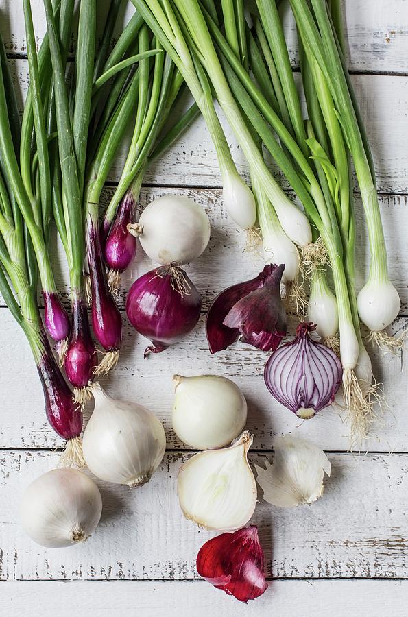Red And White Onions On A White Wooden Table Photograph by Sabine Steffens