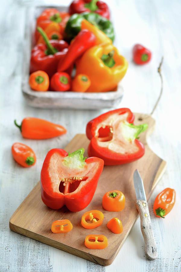 Red And Yellow Peppers, Partly Sliced Photograph by Mariola Streim