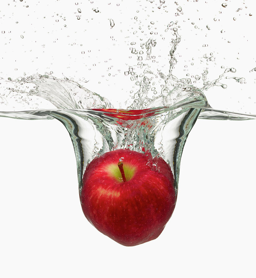Red Apple Splashing In Water Photograph by Don Farrall