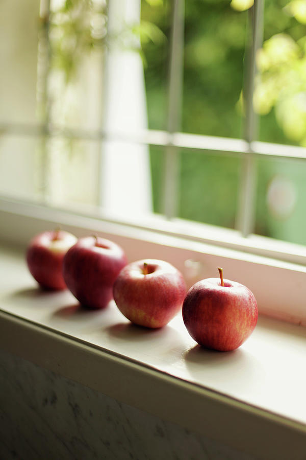 Red Apples In Line On White Wooden A Photograph by Les Hirondelles Photography