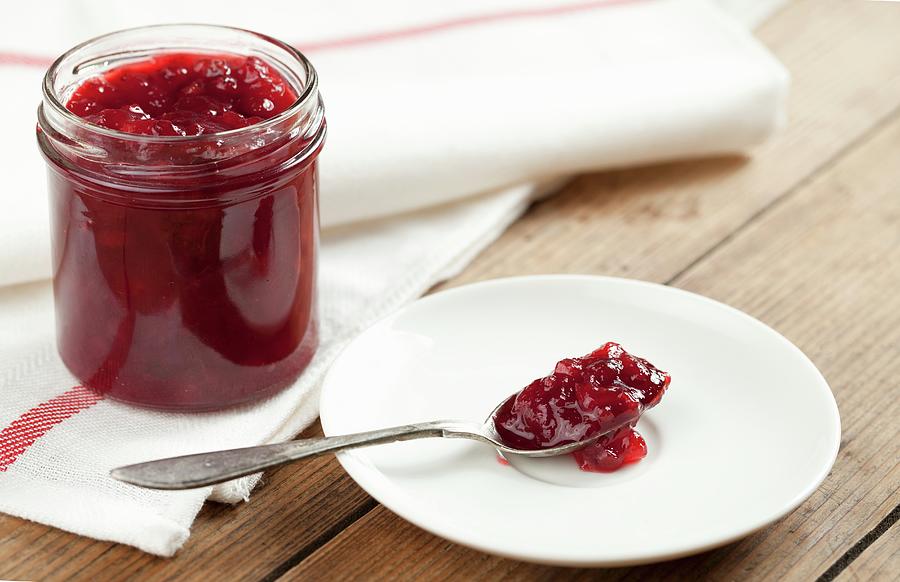Red Berry Jam In Jar And On A Spoon Photograph by Pawel Worytko