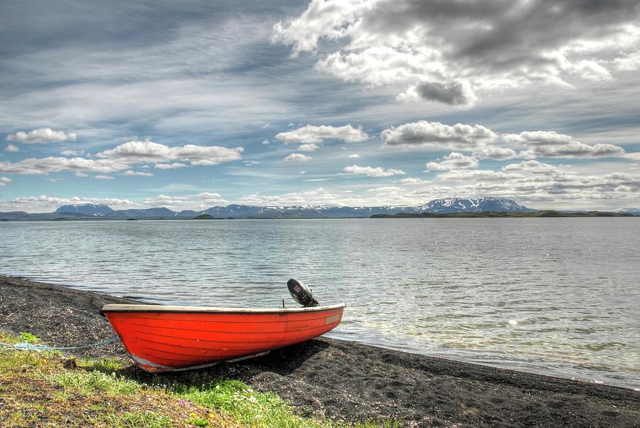 Red boat on Lake Myvatn Photograph by Karen Smale