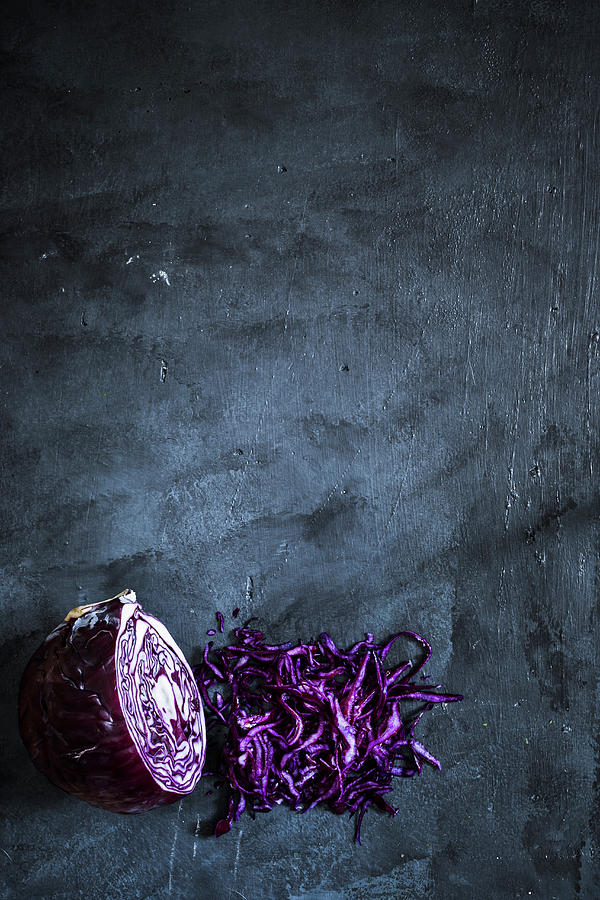 Red Cabbage Halved And Shredded On A Dark Grey Surface Photograph by Maricruz Avalos Flores